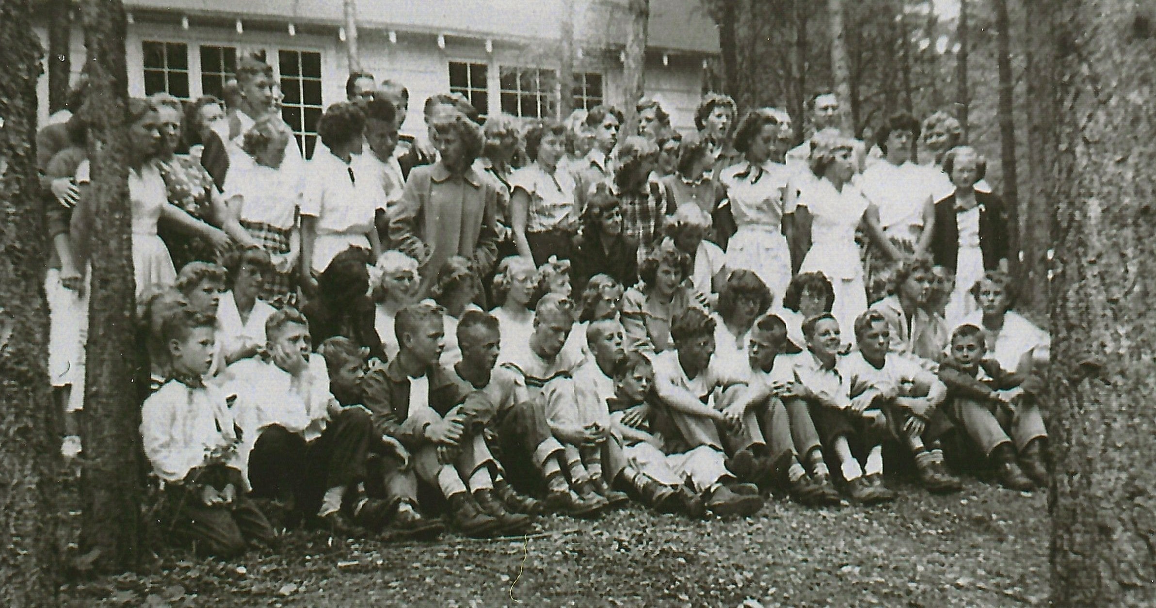 This photo during a 1940s family camp week was taken between the dining hall and the lake.