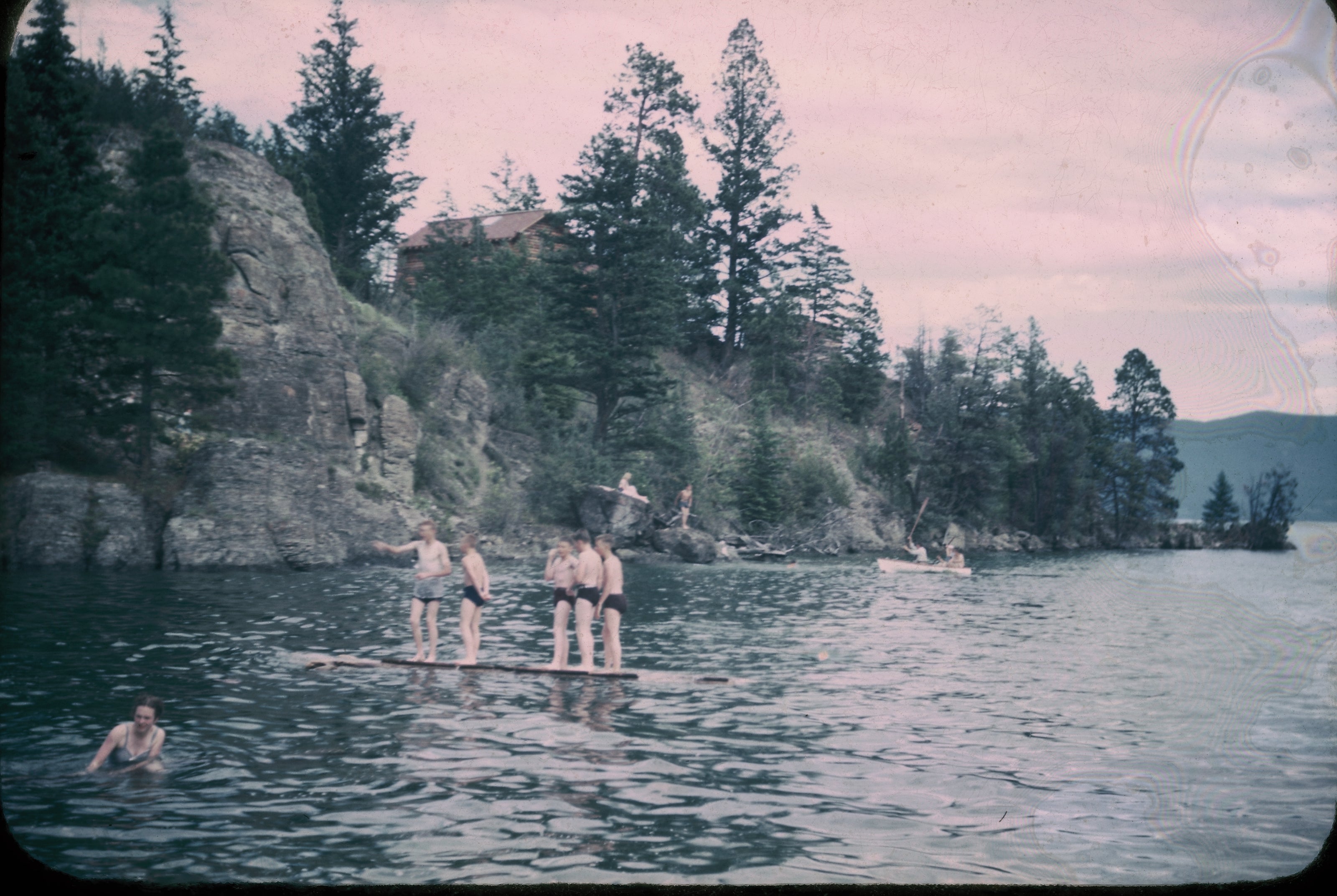 Western artist Leonard Lopp’s cabin, which he named "Rocky Haven" can be seen on the cliff above the Camp's swimming area.  There were no colorful water trampolines  or water slides in the 40s, just logs that rolled in from the lake. 