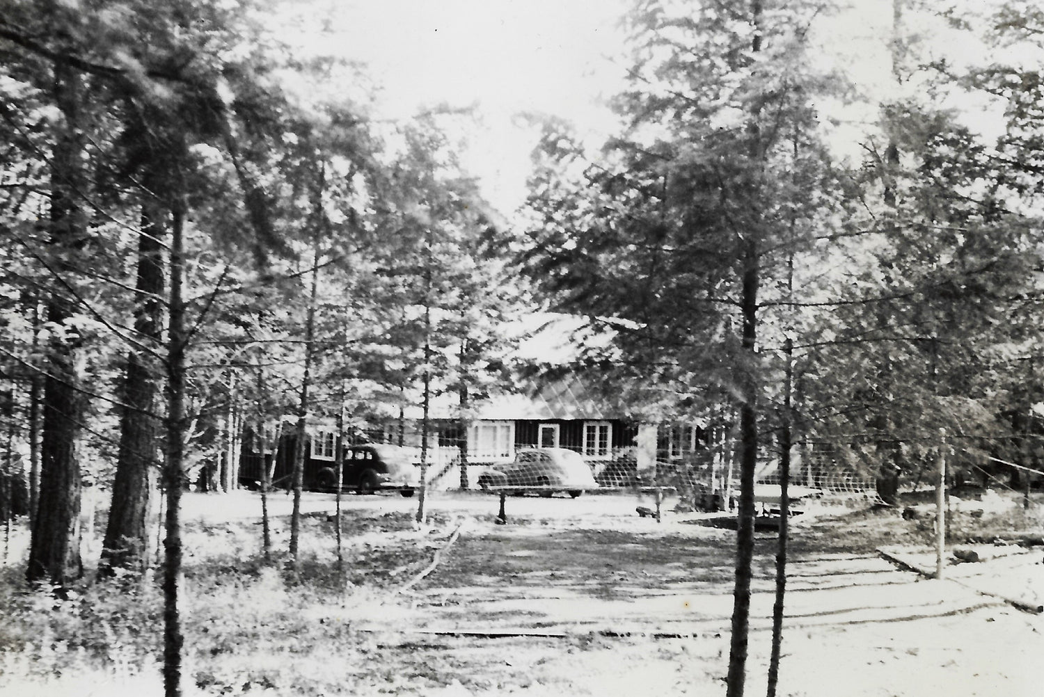 By the summer of 1943 the Dining Hall was usable in spite of the tarpaper exterior.  And there was a a volley ball court in front.