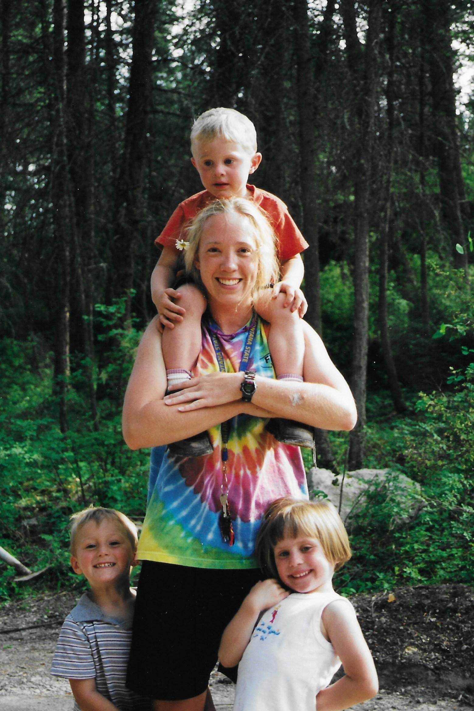 Summer counselor and young camper smiles