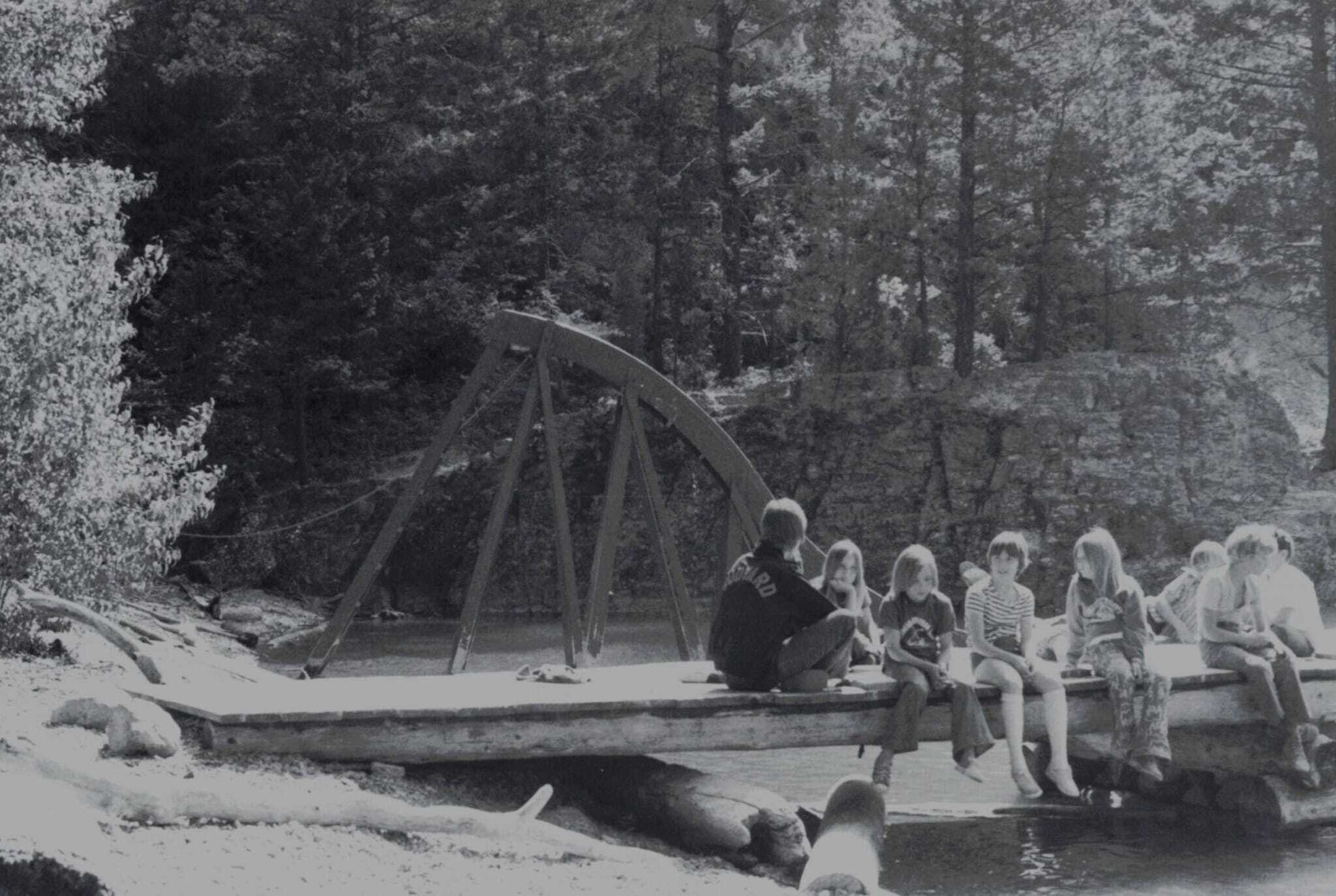 Campers relax on the swimming dock during small group time.